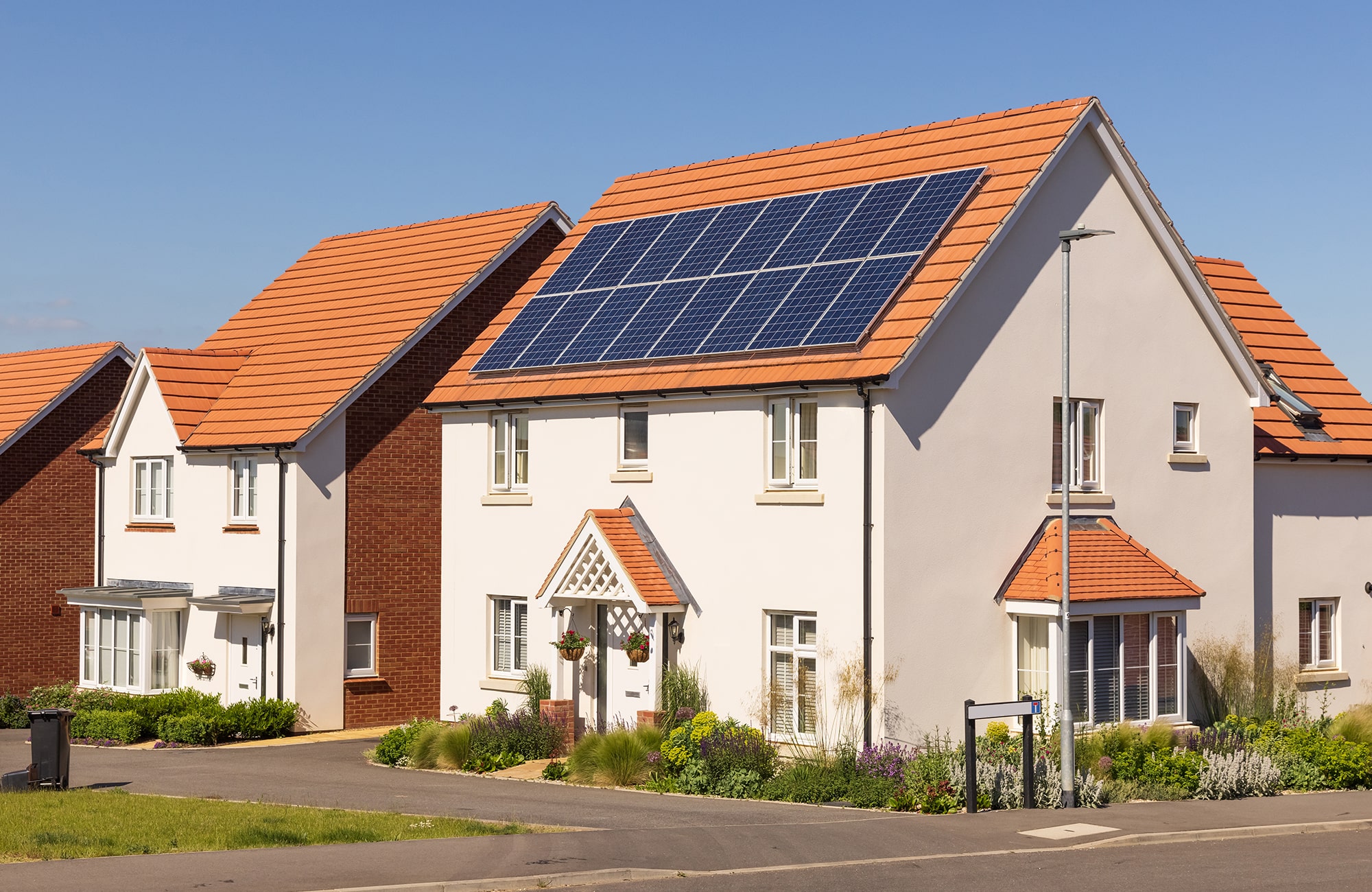 Modern newly built houses with solar panels on the roof on a sunny day