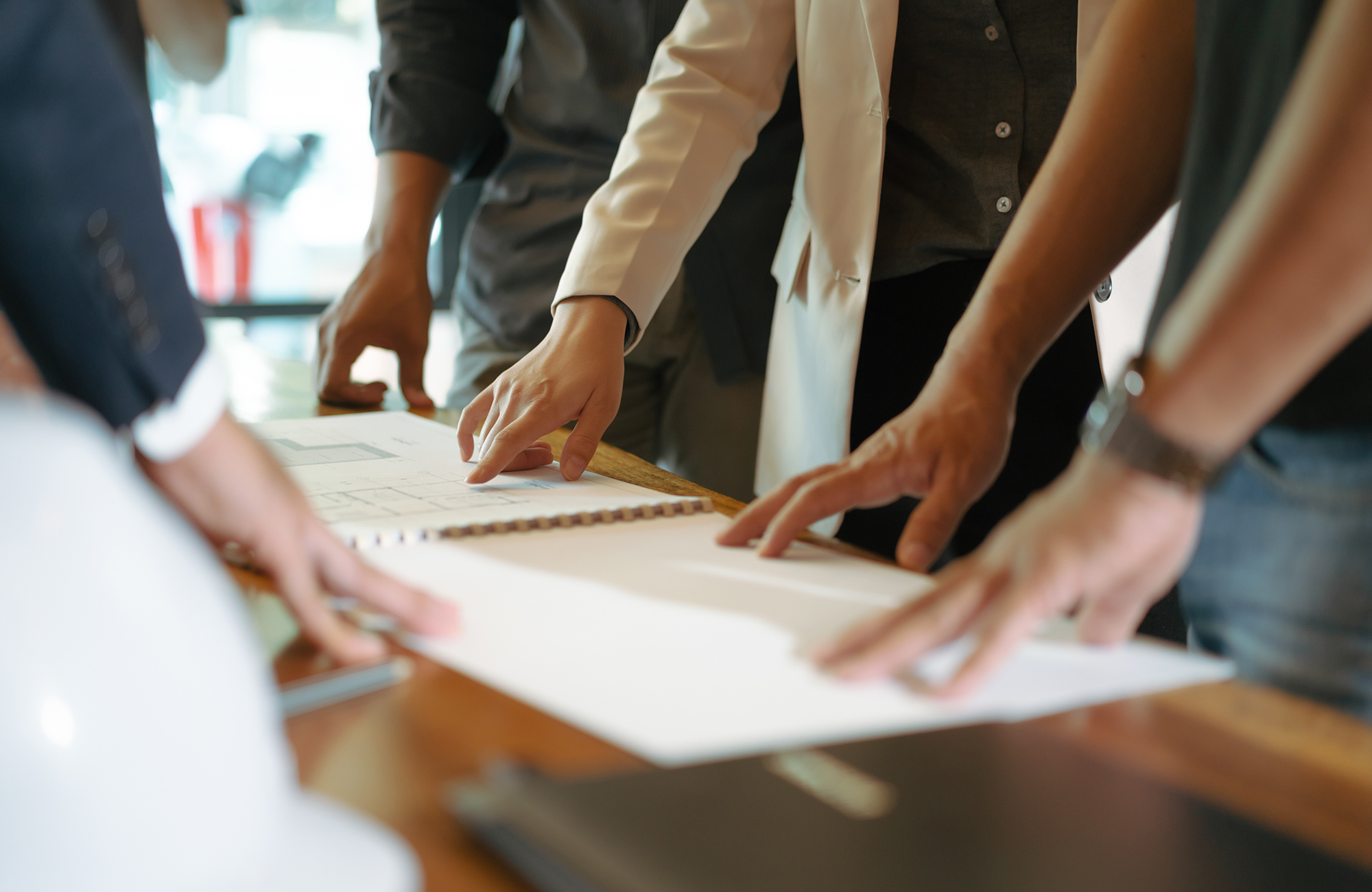 Property developers looking and pointing at plans